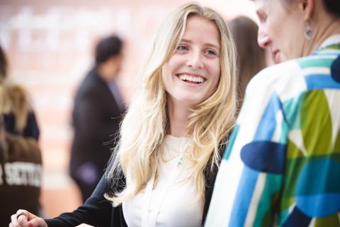 Isabelle O'Toole smiles at a friend as she mingles at a mixer.