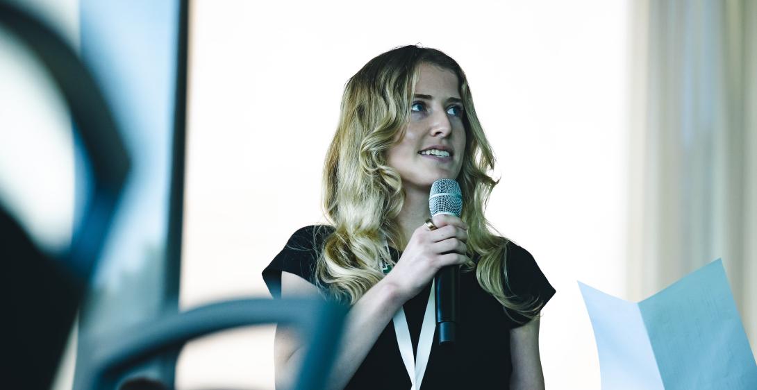 Isabelle O'Toole speaks into a microphone during a co-lab.